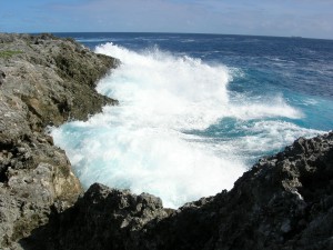 Wave crashing against rock in Fiji